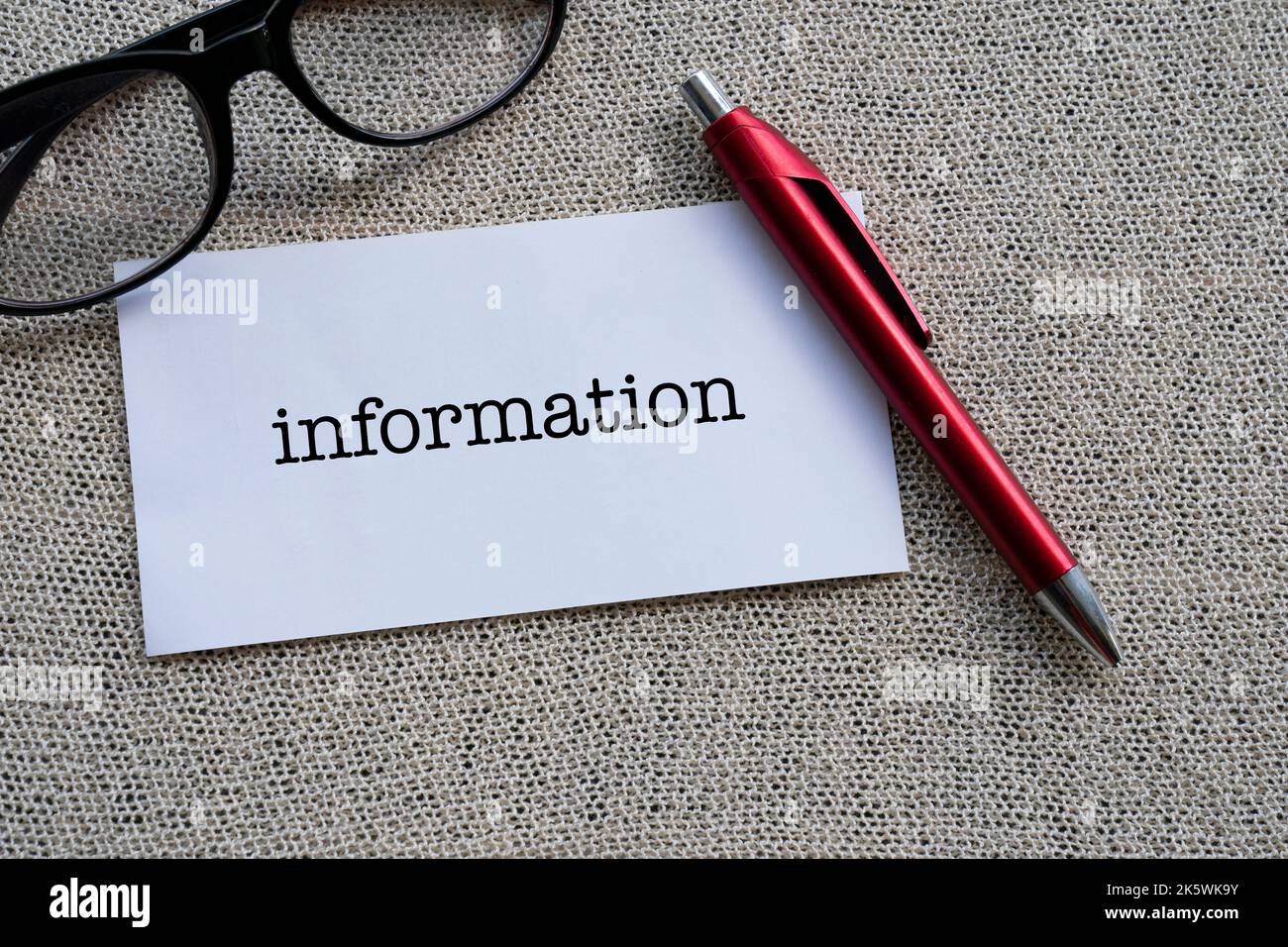 The word INFORMATION on white paper with a red pen Stock Photo