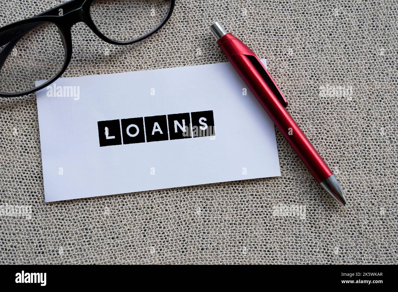 The word LOANS on white paper with a red pen Stock Photo