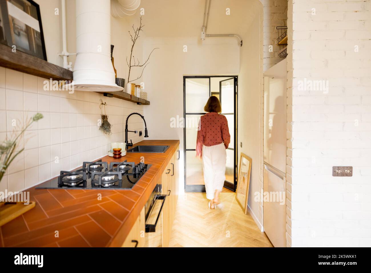 Modern kitchen interior with female person Stock Photo - Alamy