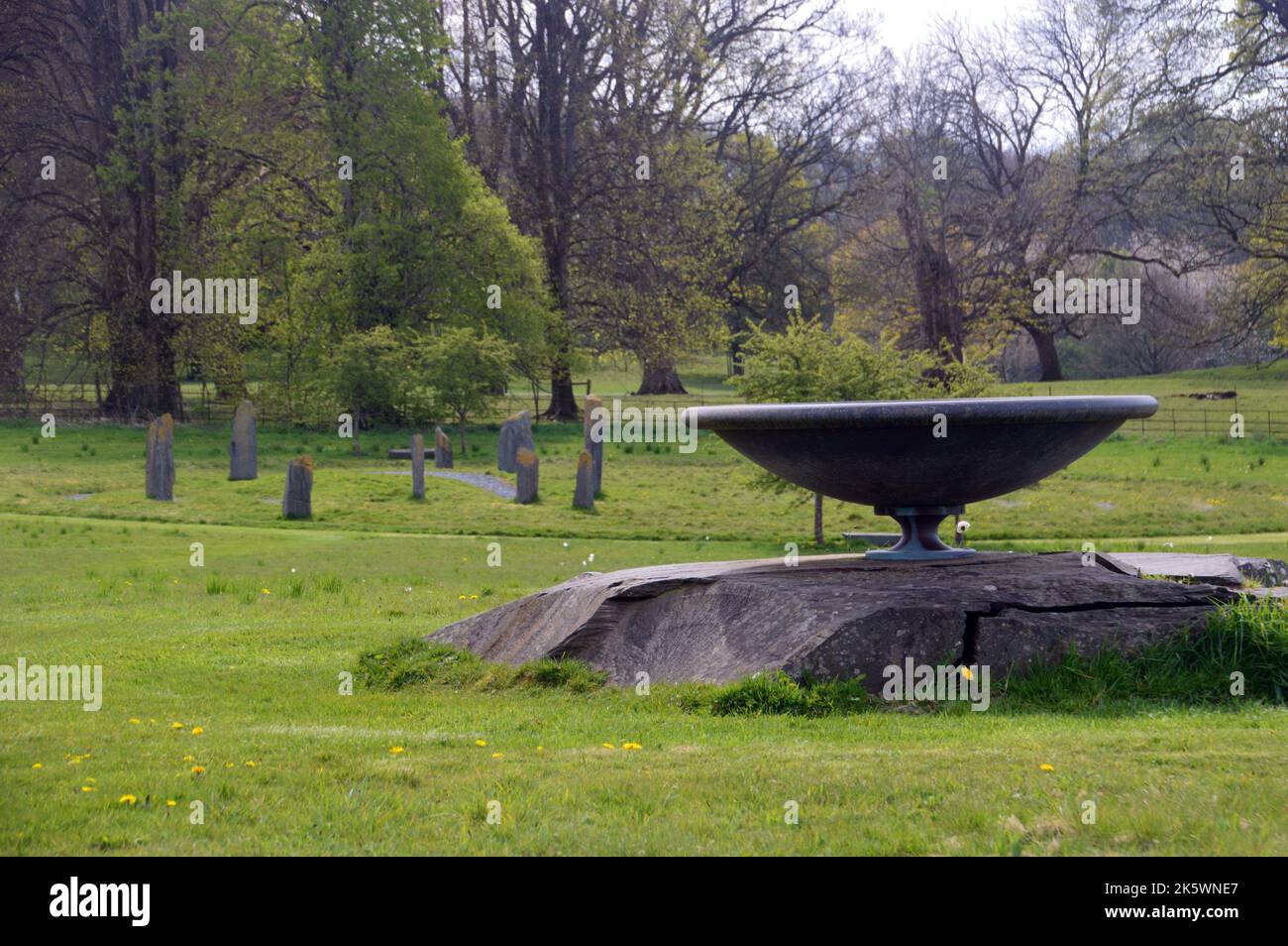 Large Blue Slate Sundial by the Stone Labyrinth on the Edge of the Wildflower Meadow at Holker Hall & Gardens, Lake District, Cumbria, England, UK. Stock Photo