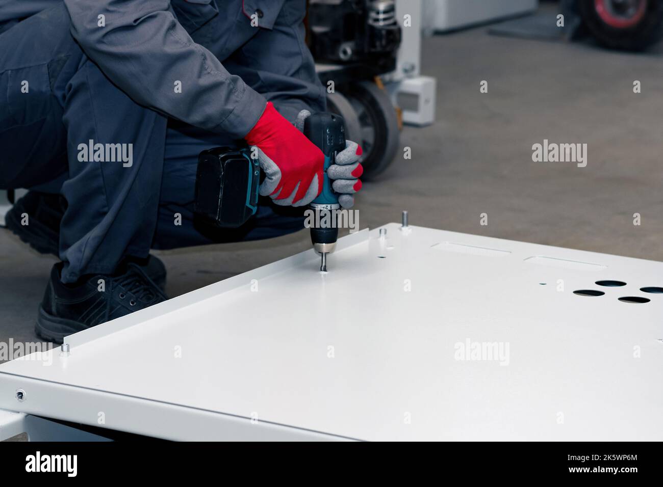 assembly of a metal structure in the workshop using a screwdriver Stock ...
