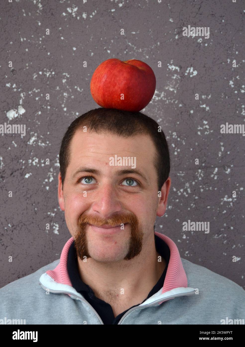 man and apple on a head Stock Photo