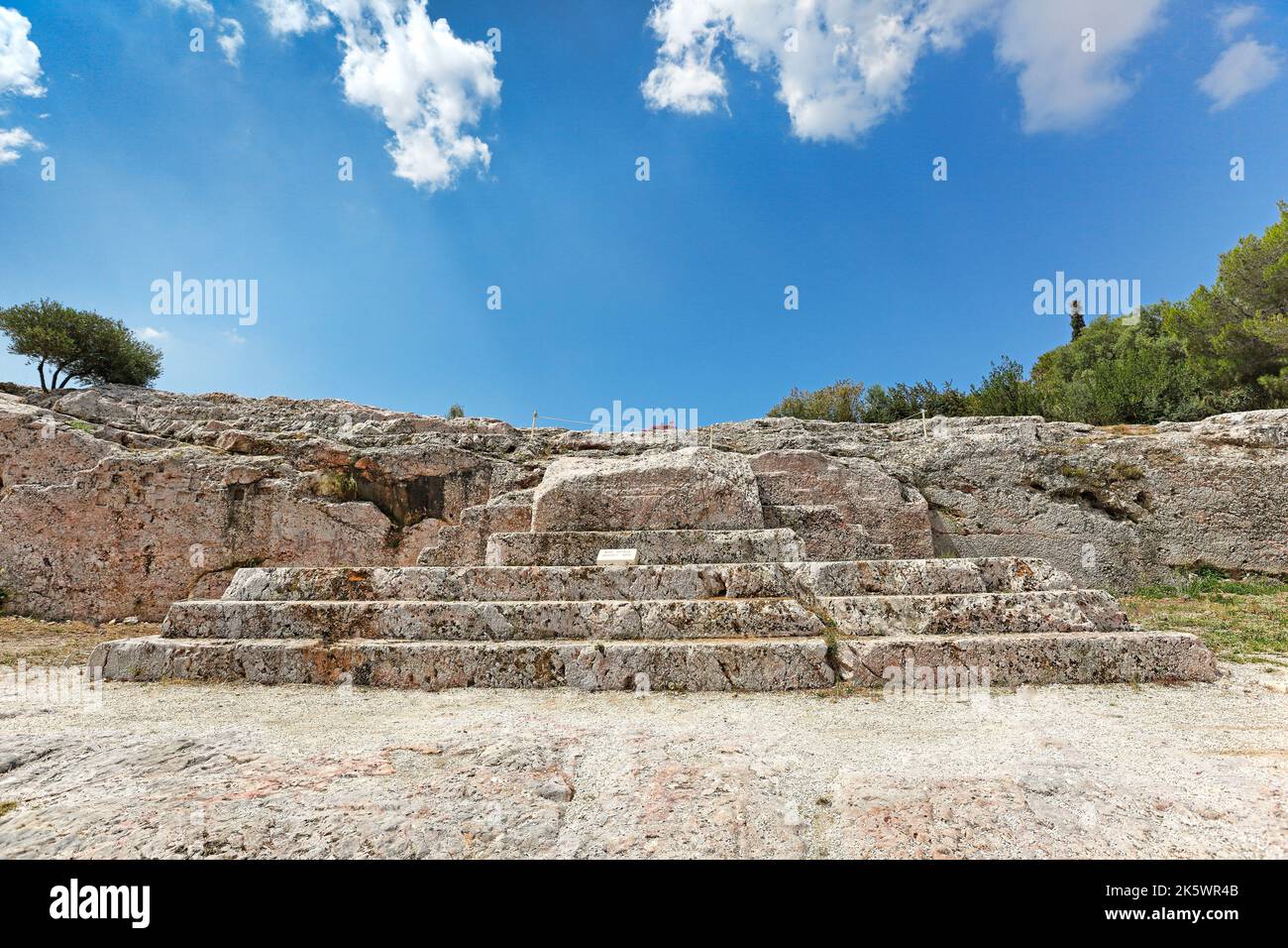 The Pnyx (507 B.C.) with the carved steps of the speaker's platform (bema)  near the Athenian Acropolis, Greece. Pericles, Demosthenes etc. spoke here Stock Photo