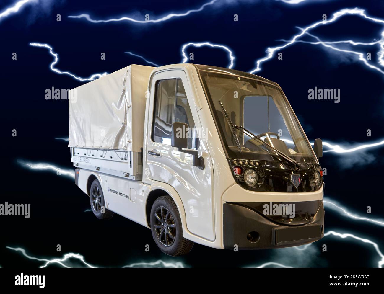 Tropos Motors electric car for last mile transportation with full electric drive in front of a dark background with lightning, Hannover, Germany, Sept Stock Photo