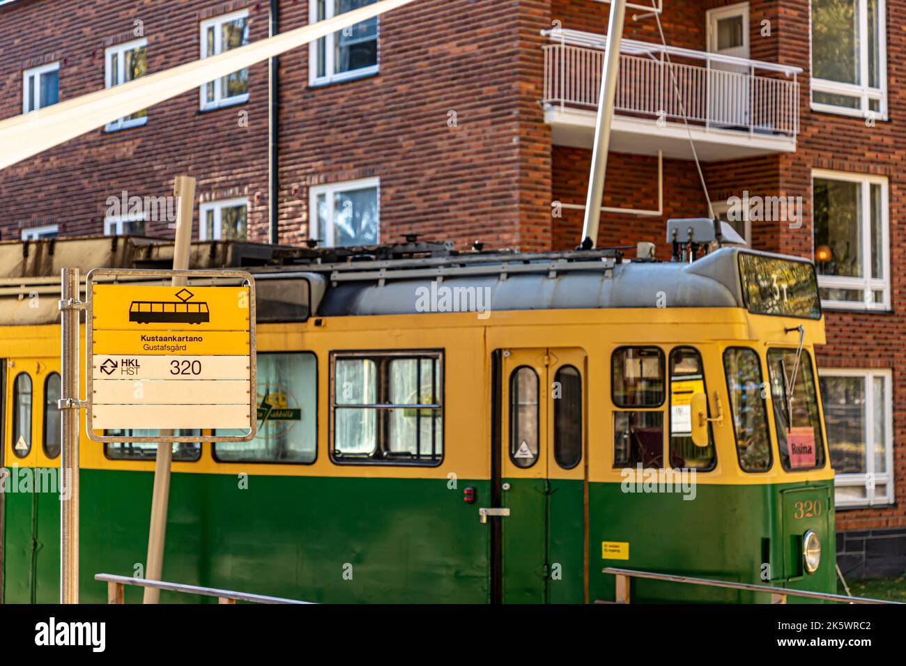 Decommissioned HKL motor tram 320 with '3T' headsign, parked in front of Kustaankartano senior centre building B in Oulunkylä, Helsinki, Finland. Stock Photo