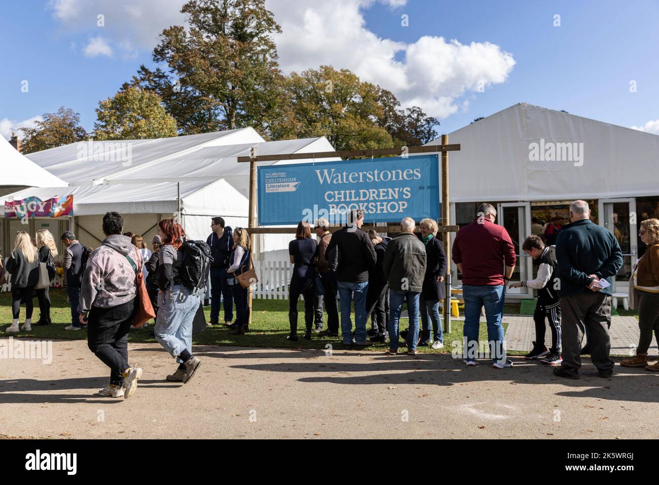 Cheltenham Literature Festival, Gloucestershire. Festival attendees enjoy the warm sunny weather within the Literature festival grounds. Stock Photo