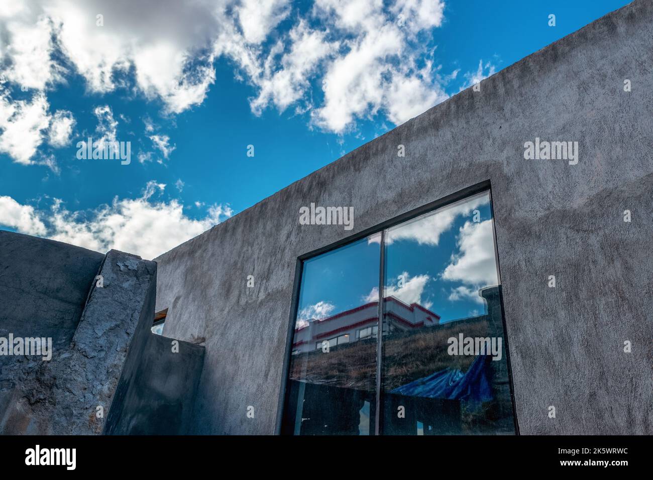 Huge window of a industrial building or depot above the blue sky with plufy clouds. High quality photo Stock Photo