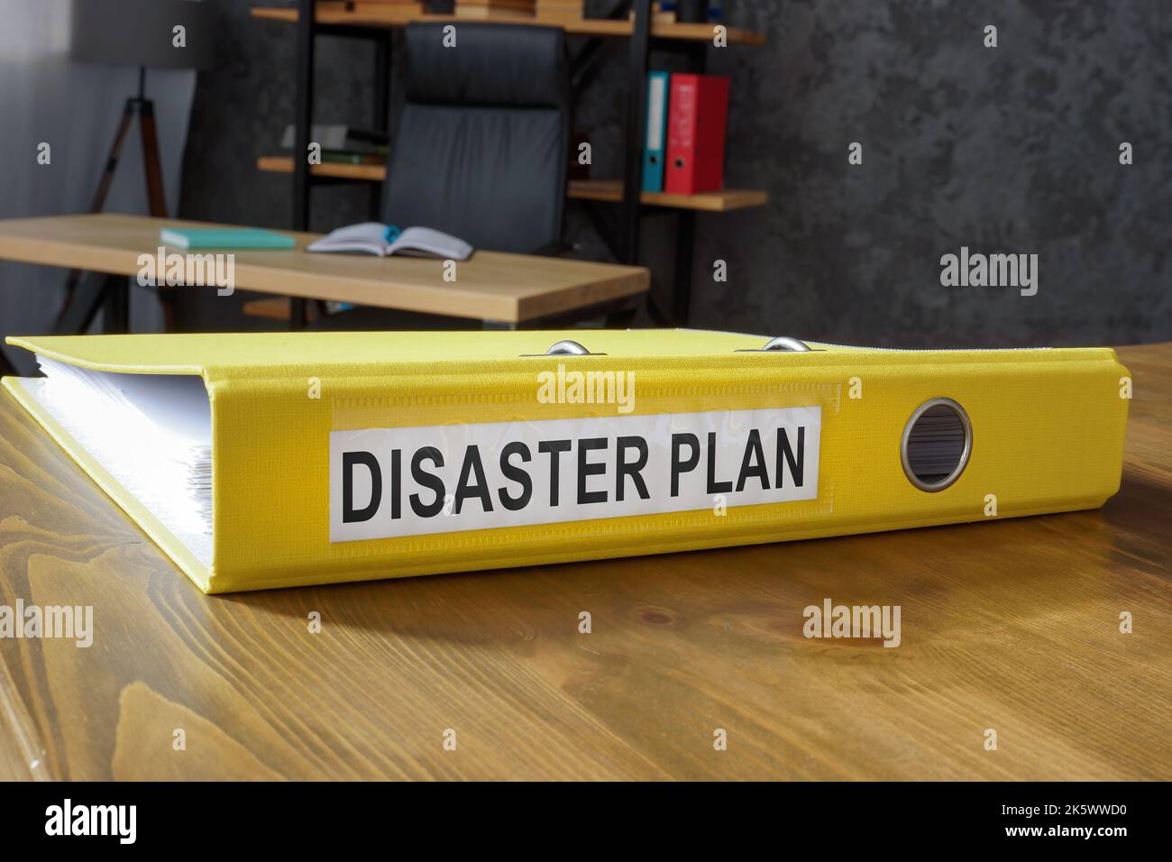 Yellow folder with disaster plan in the office. Stock Photo