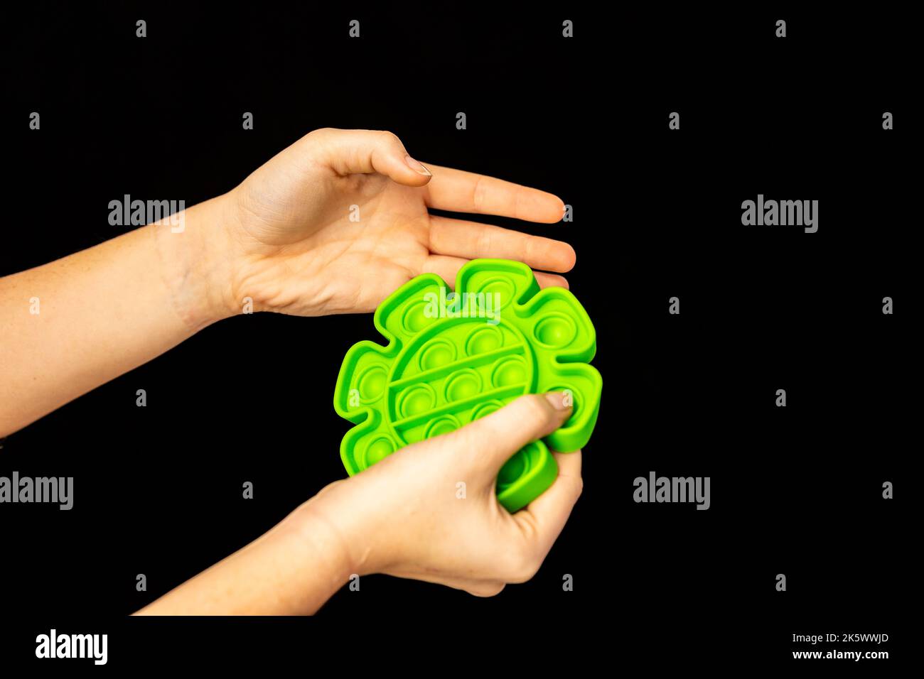 Child playing with a popping fidget toy Stock Photo