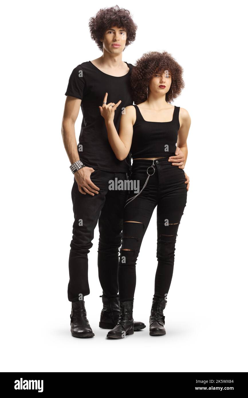 Full length portrait of a trendy young couple in black clothes gesturing rock and roll sign isolated on white background Stock Photo