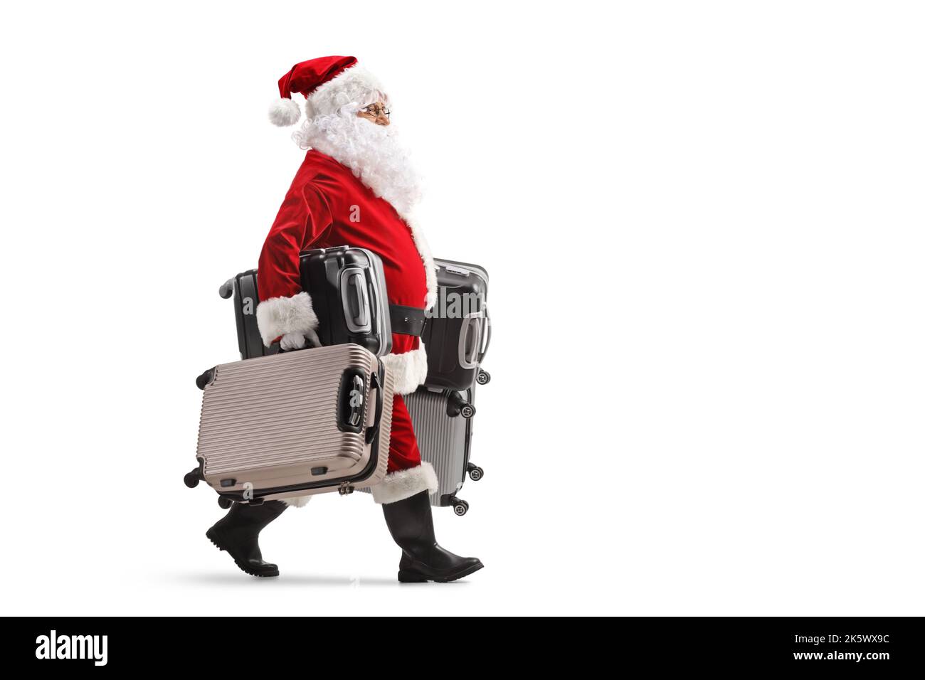 Full length profile shot of santa claus walking and carrying many ...