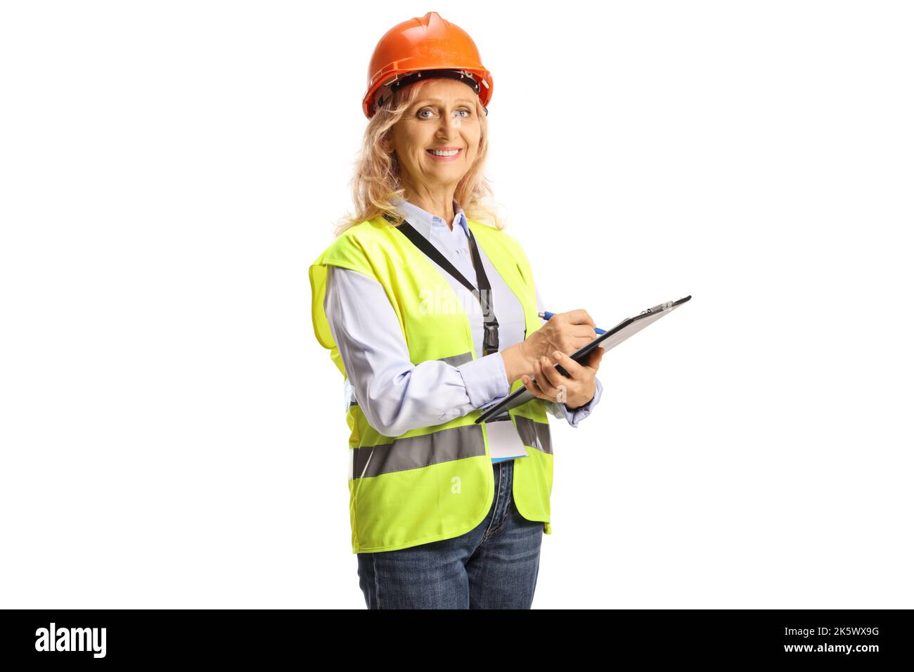 Female engineer with a safety vest and helmet holding a document and