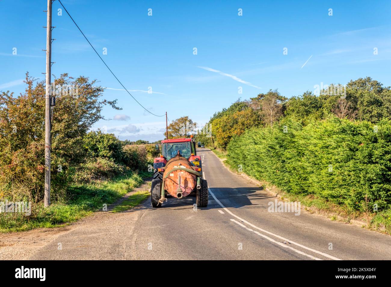 Tractor on a country road in Norfolk. Stock Photo