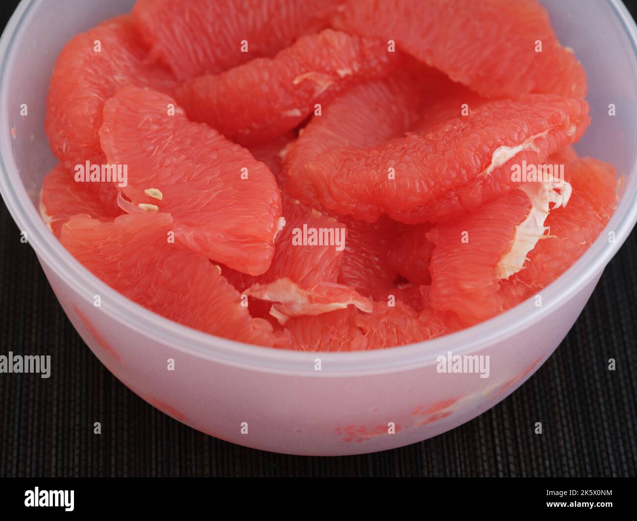 A bowl with grapefruit slices in it. Close up. Stock Photo