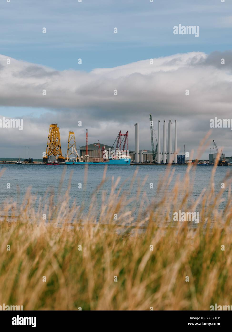 Distant wind turbine factory in Cromarty, Cromarty Firth, Black Isle, Ross & Cromarty, Highland, Scotland UK Stock Photo