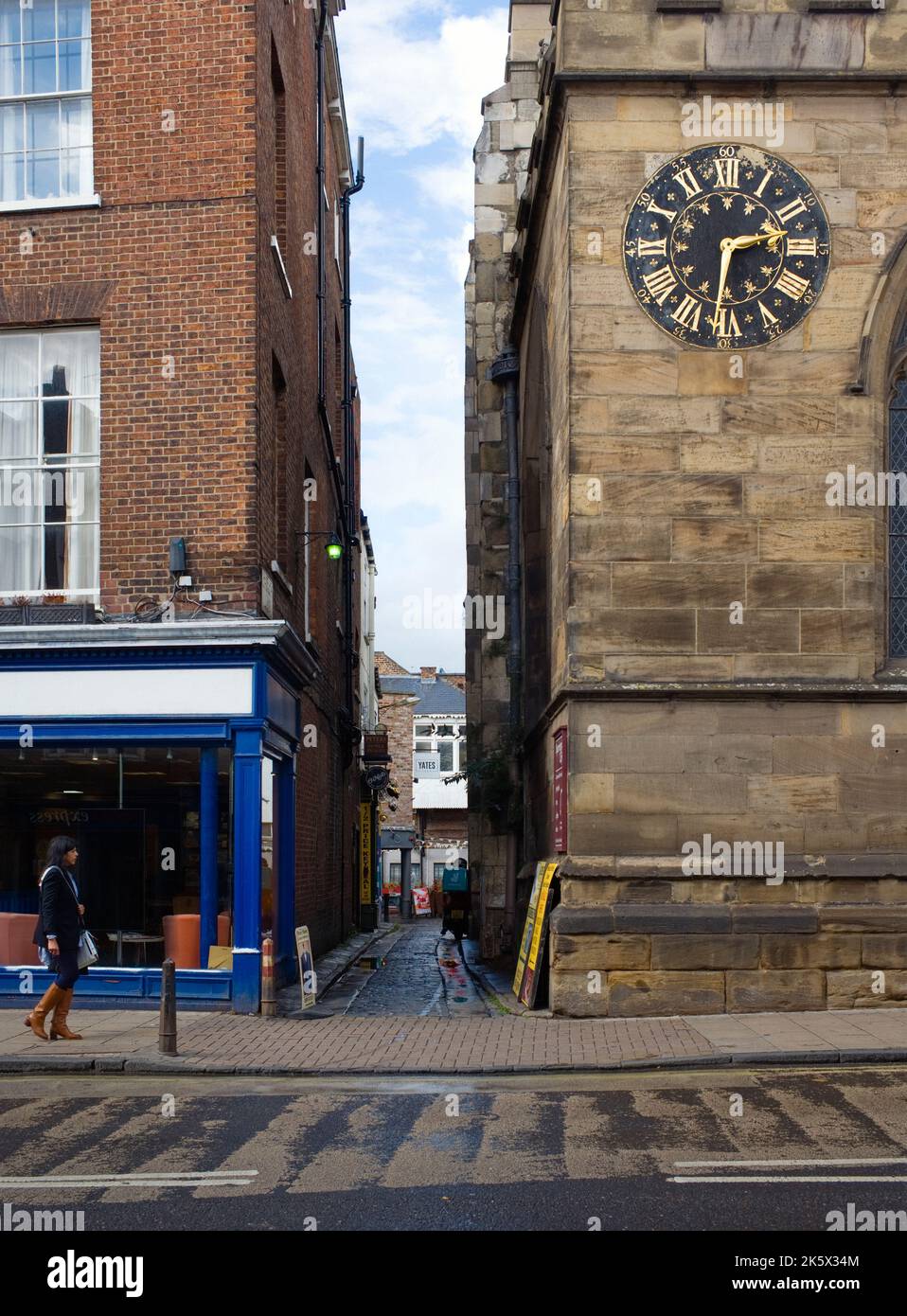 Church Lane with St Michael's church clock on Low Ousegate in the city of York Stock Photo