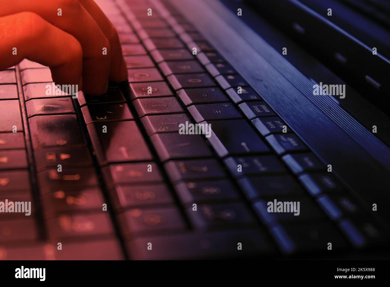 Hand on the keyboard with Russian layout. The concept of information protection, cyber attacks. The concept of work from home, business, online shopping. Stock Photo