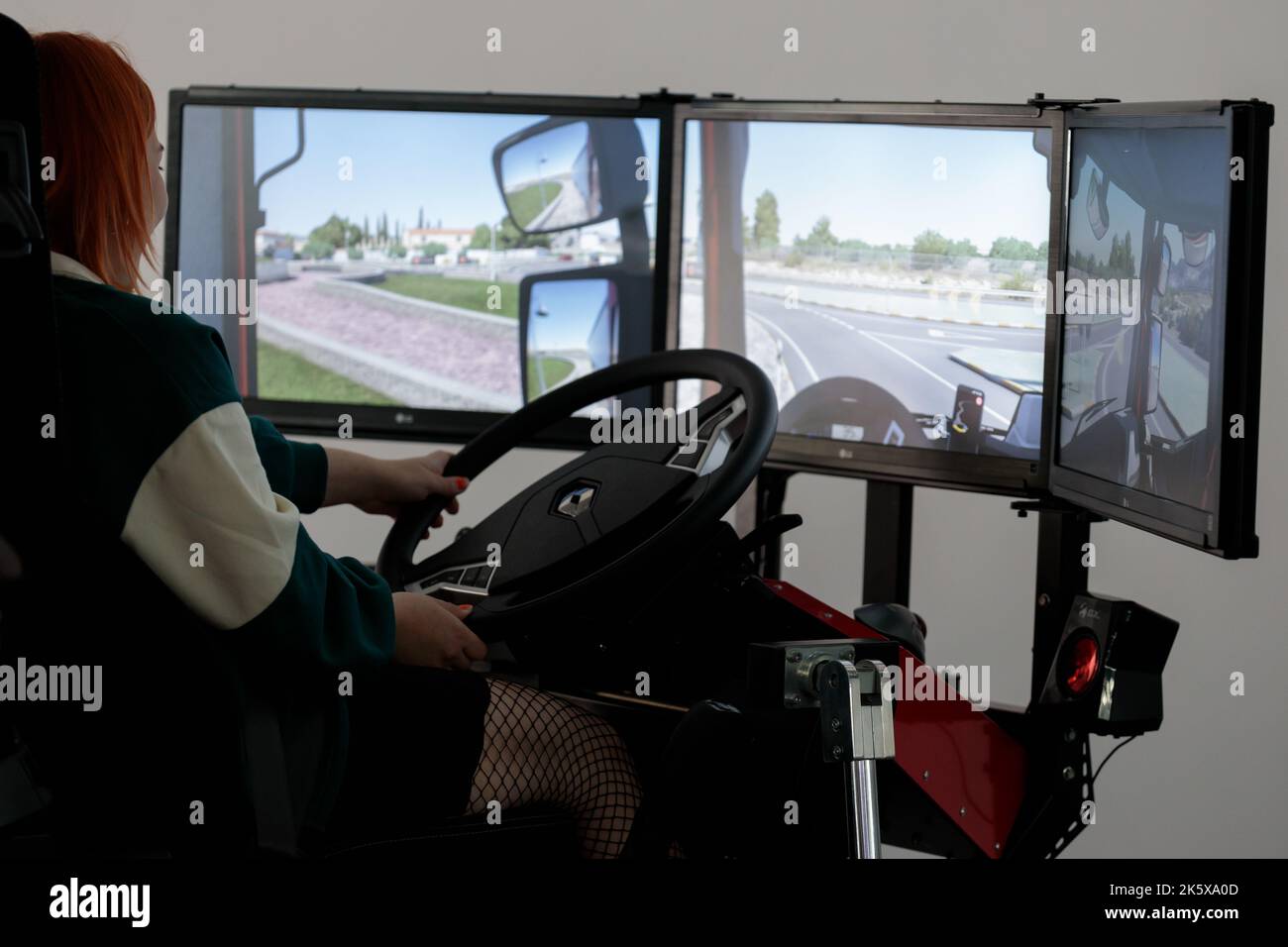 Poland, Poznan - October 09, 2022: Poznan Game Arena, a video game trade show. Girl plays car simulator Stock Photo