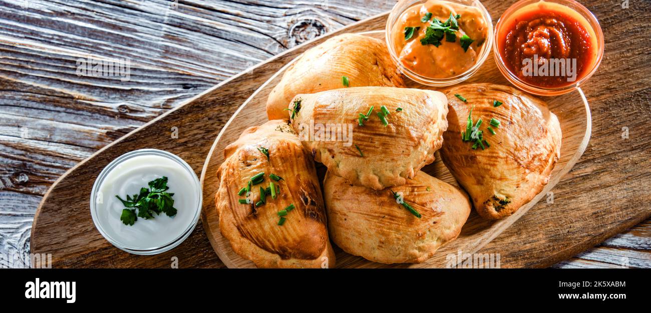 Composition with a dish of oven-baked pierogi Stock Photo