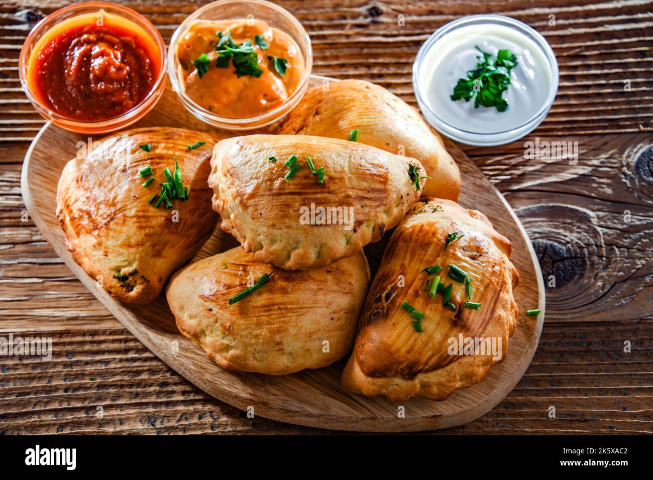Composition with a dish of oven-baked pierogi Stock Photo