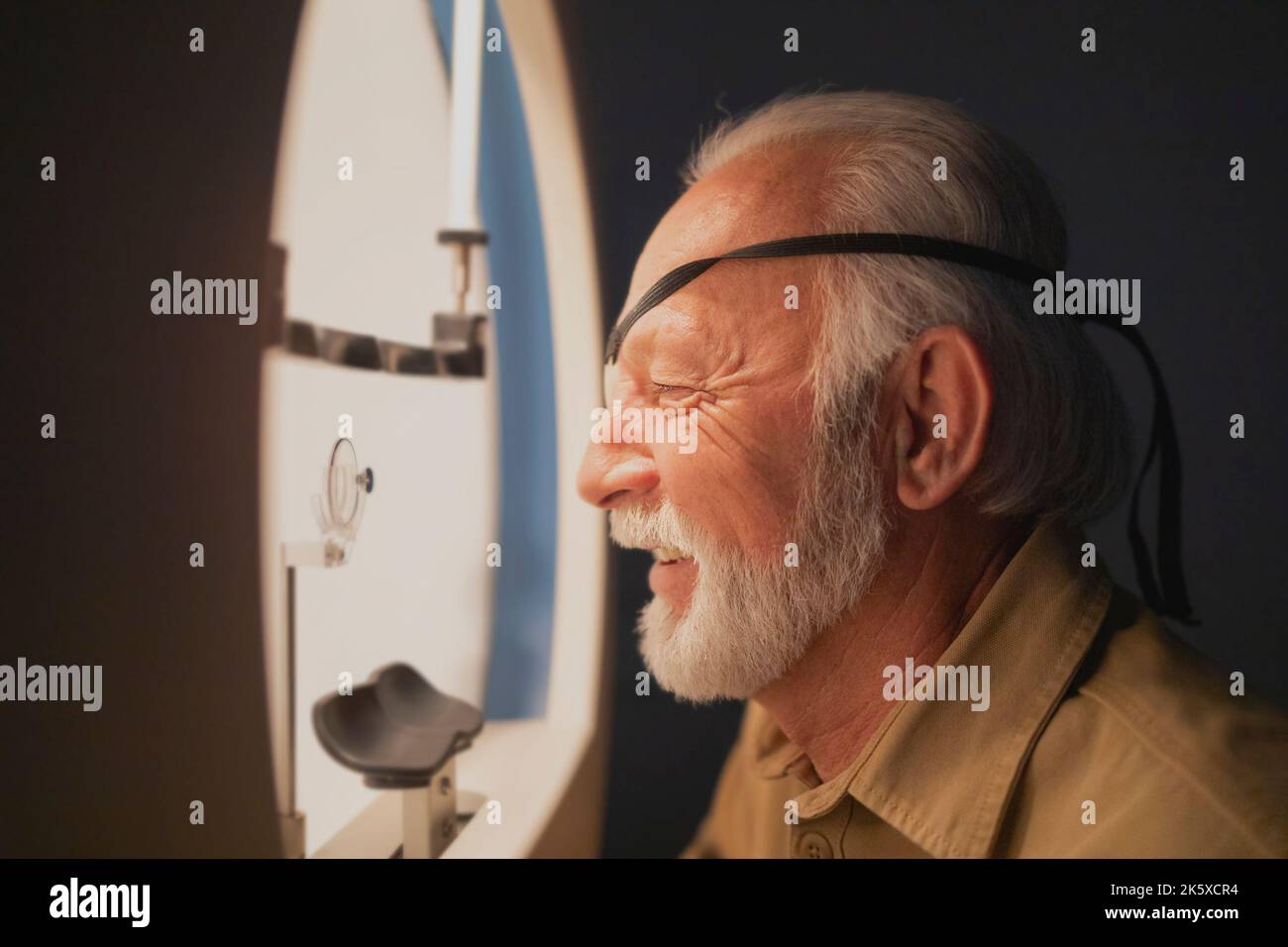 Elderly man during professional eye examination Stock Photo