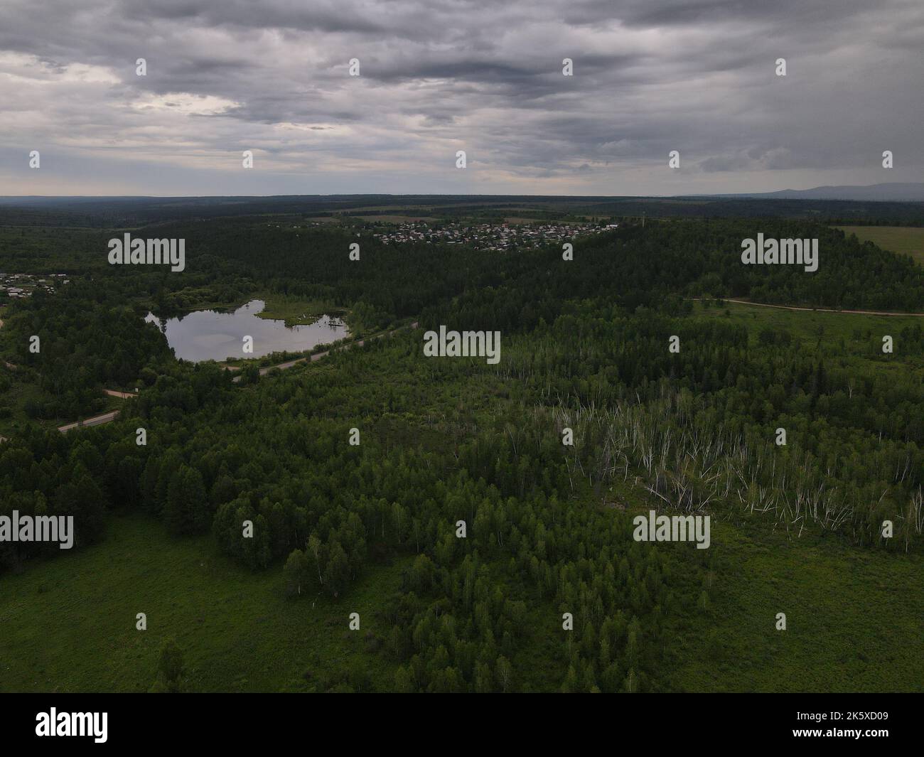 An aerial view of a green field with trees and river Stock Photo - Alamy