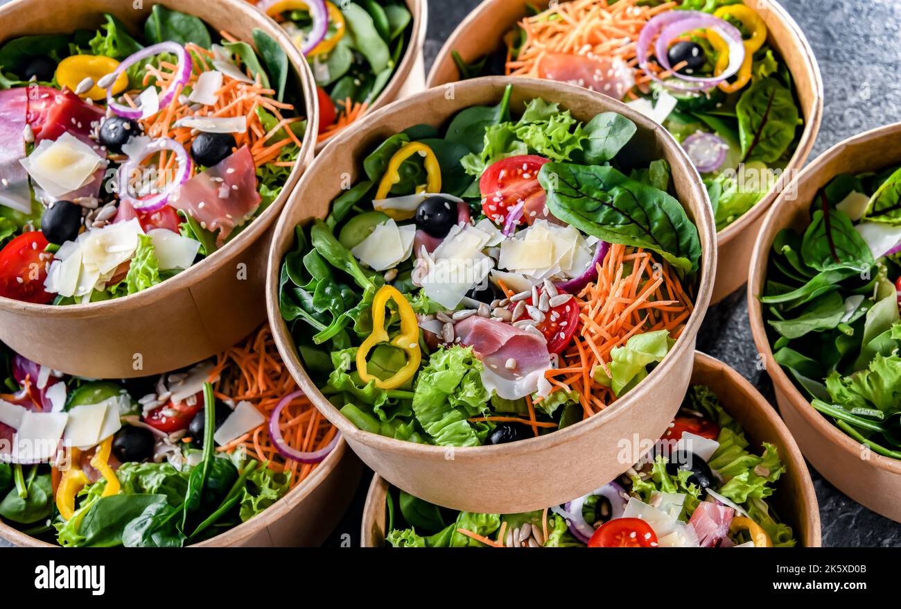 Round paper boxes with prepackaged vegetable salads ready for sale