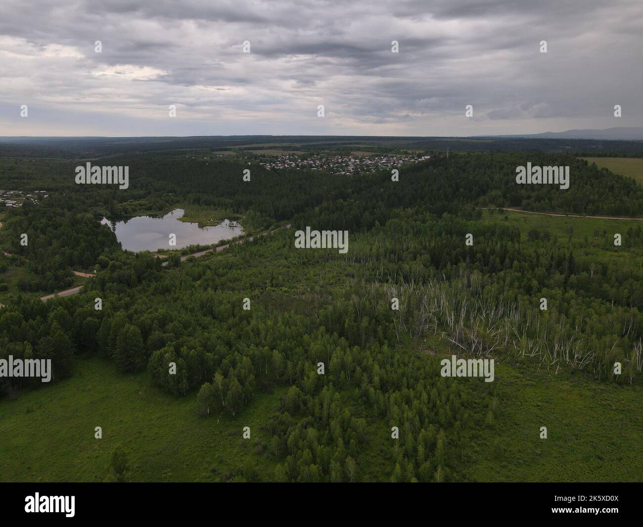 An aerial view of a green field with trees and river Stock Photo - Alamy