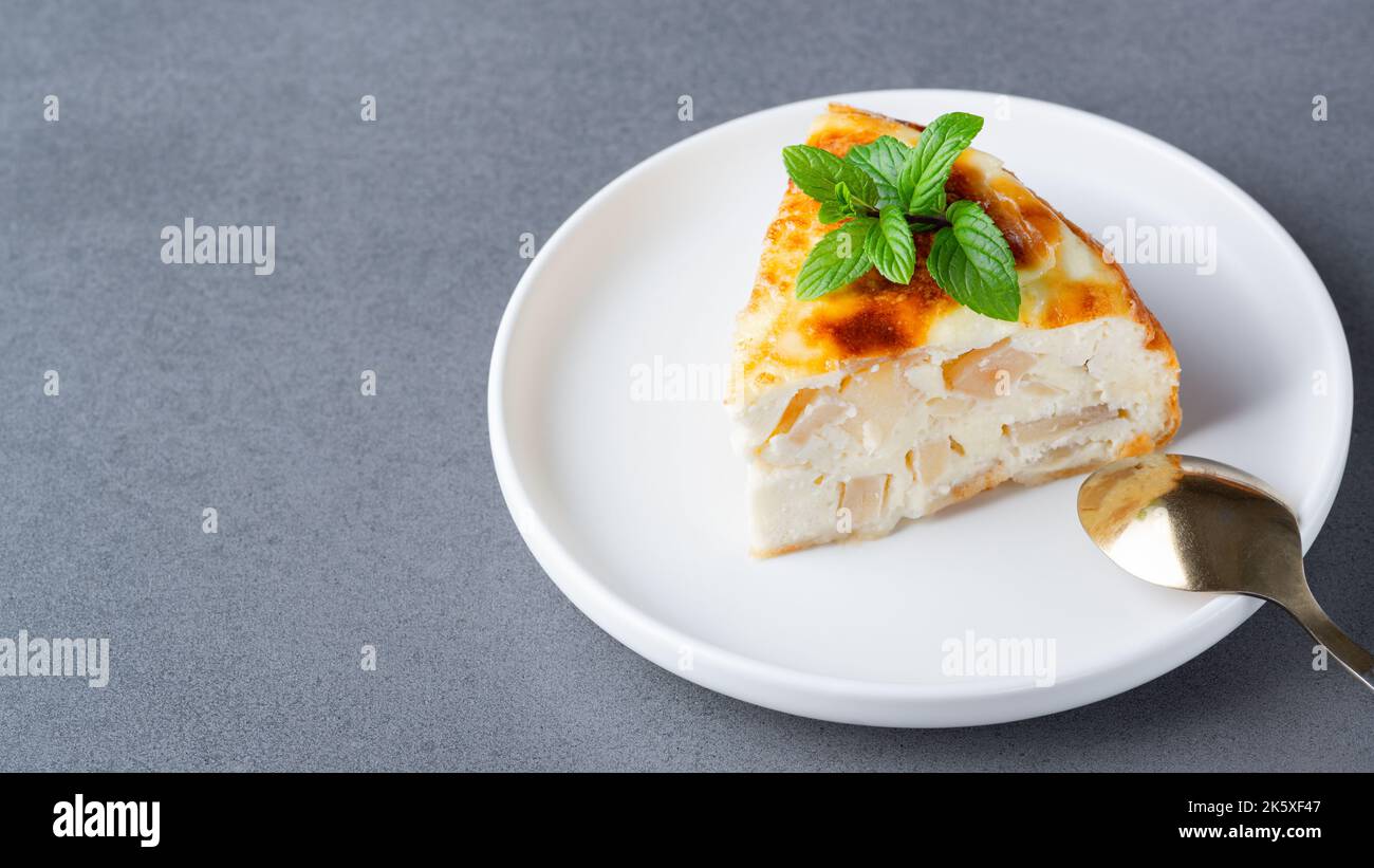 Baked Sweet Cottage Cheese casserole with apple decorated mint. Copy space Stock Photo