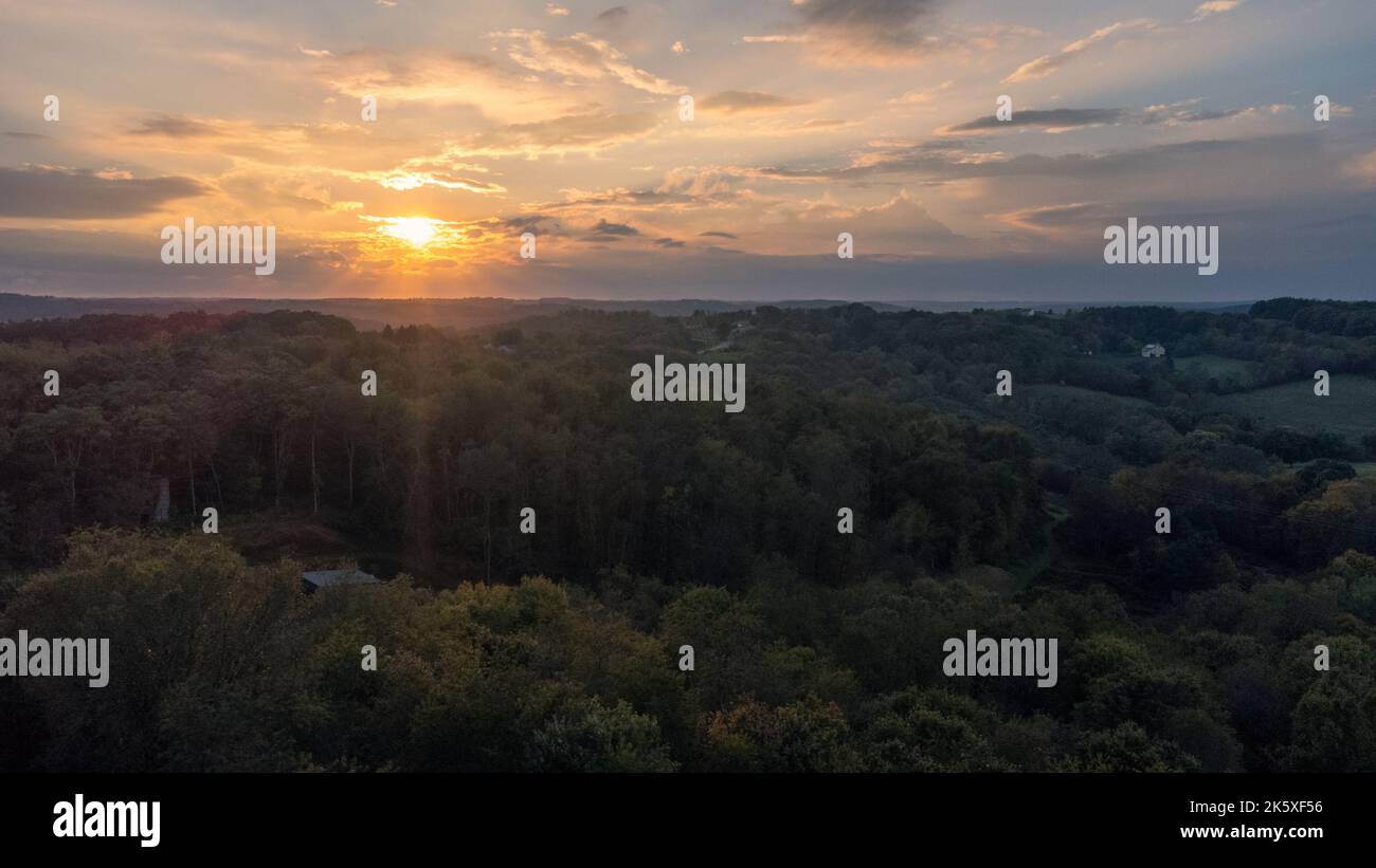 A beautiful view of a forest at a sunset Stock Photo - Alamy