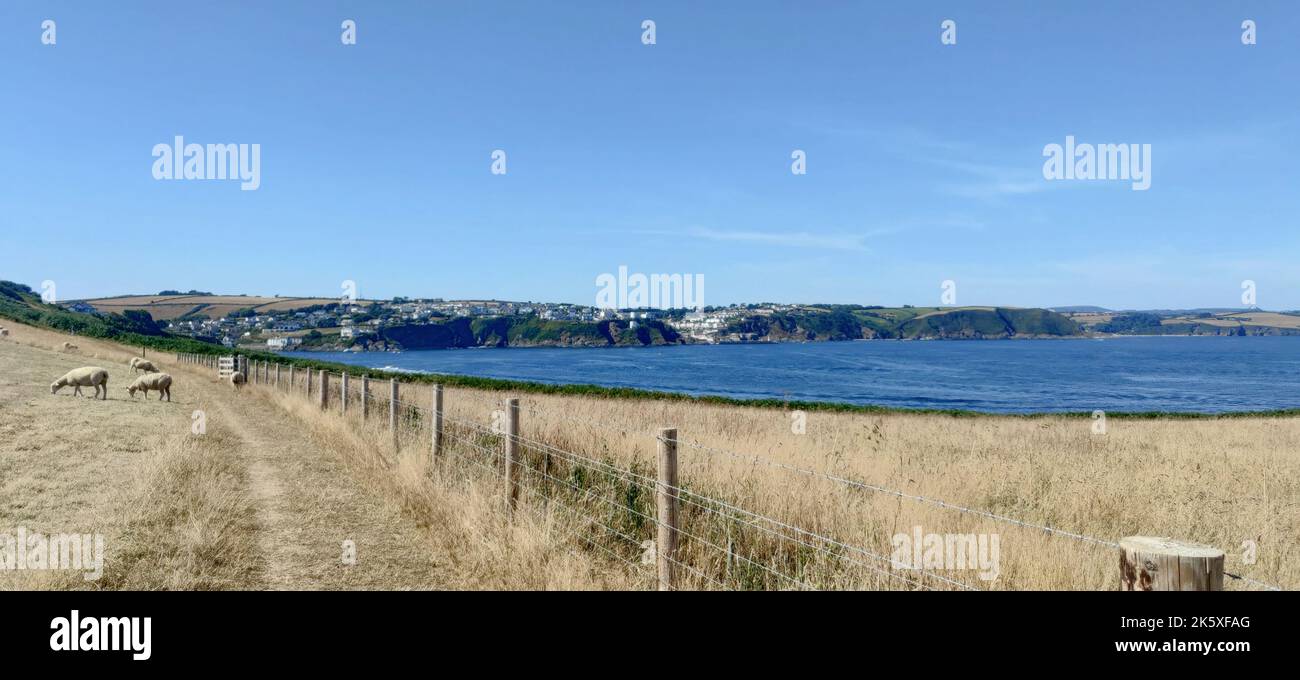 A scenery of a farm with fences on the shore of a lake under the clear ...