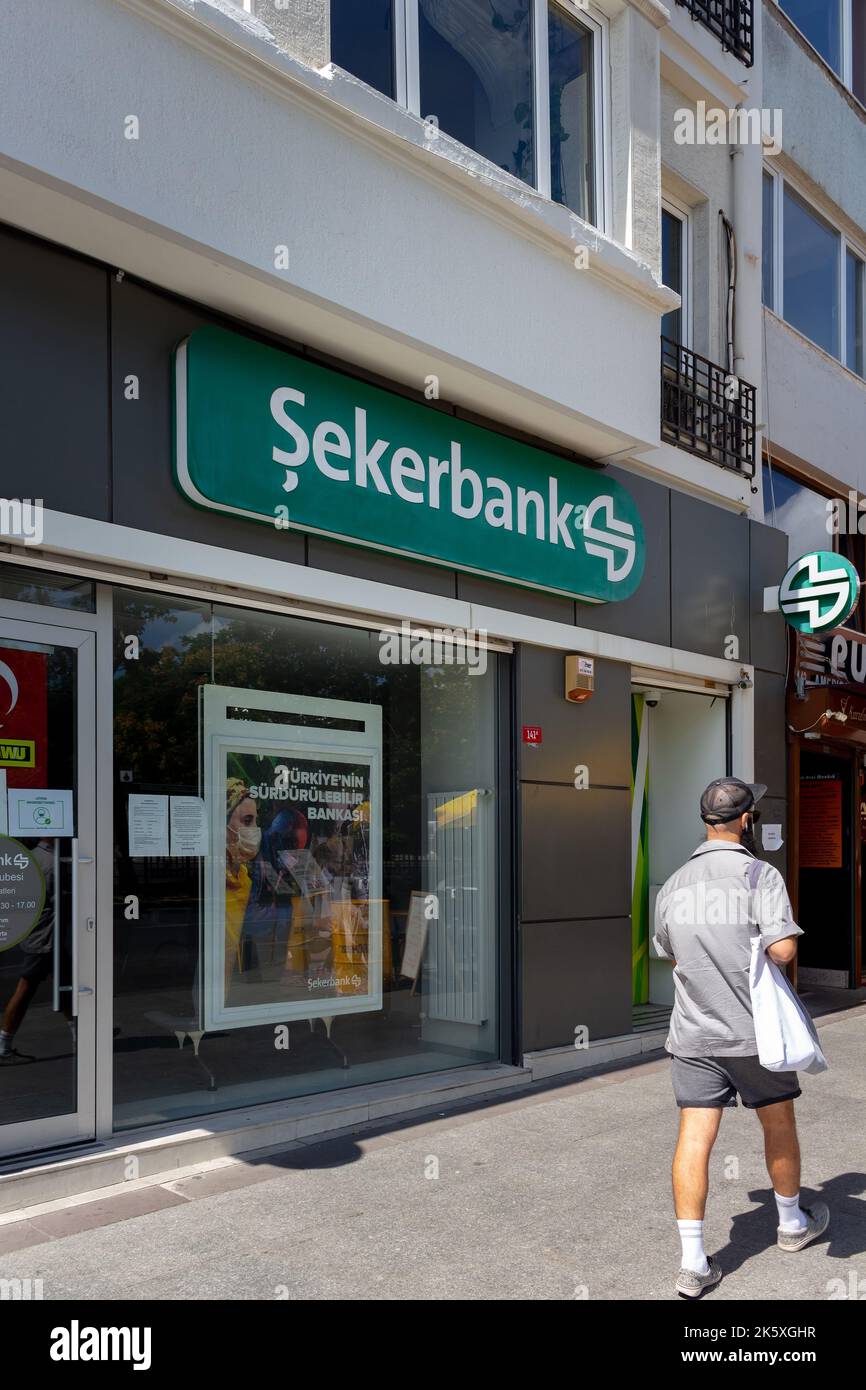 View of a young man walking by national, state owned bank's branch in Turkey. The image is captured on Halaskargazi Avenue of Sisli district of Istanb Stock Photo