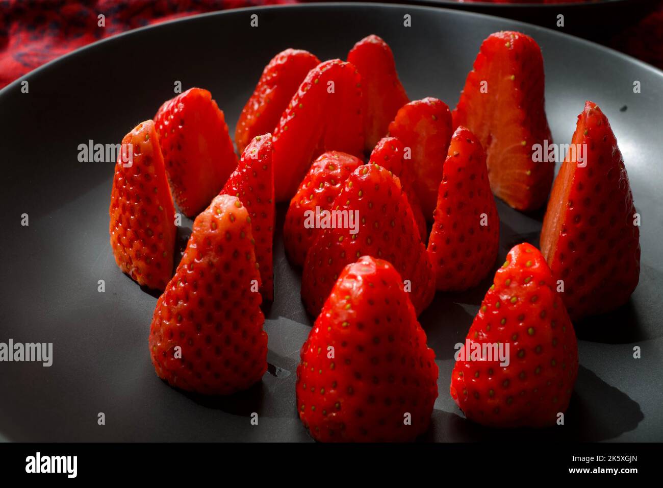 Strawberries on a black plate Stock Photo