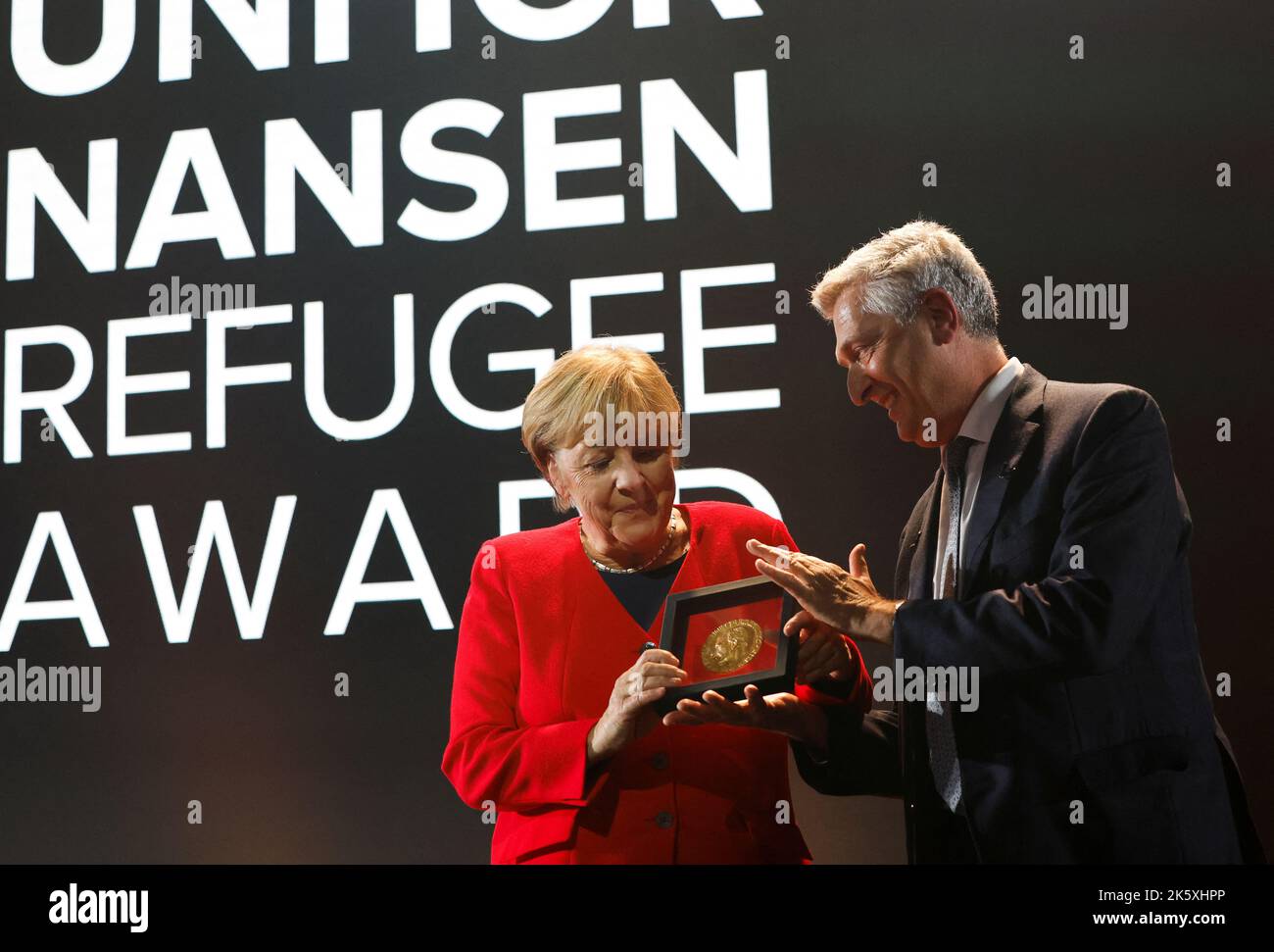 Angela Merkel receives the UNHCR Nansen Refugee Award for protecting refugees at height of Syria crisis, from United Nations High Commissioner for Refugees Filippo Grandi, during a ceremony in Geneva, Switzerland, October 10, 2022. REUTERS/Stefan Wermuth/Pool Stock Photo