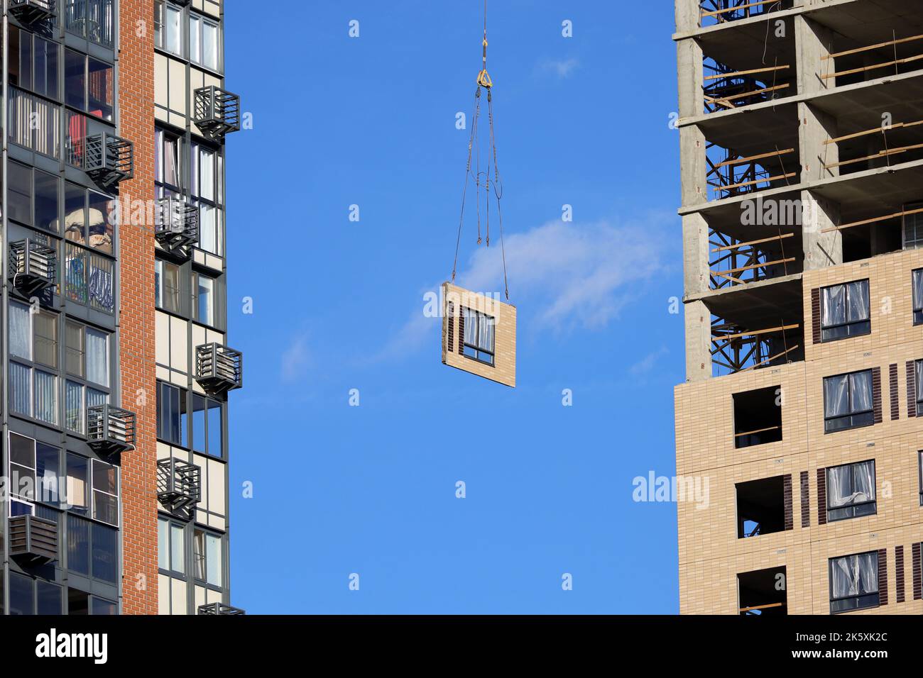Construction crane with wall and window section between new and