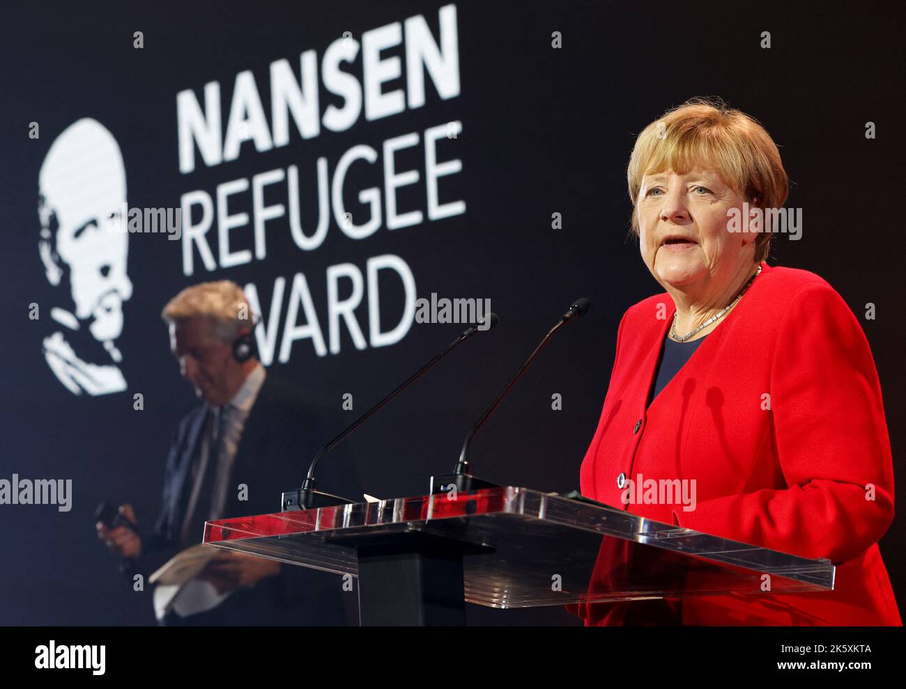Angela Merkel speaks as she receives the UNHCR Nansen Refugee Award for protecting refugees at height of Syria crisis, during a ceremony in Geneva, Switzerland, October 10, 2022. REUTERS/Stefan Wermuth/Pool Stock Photo