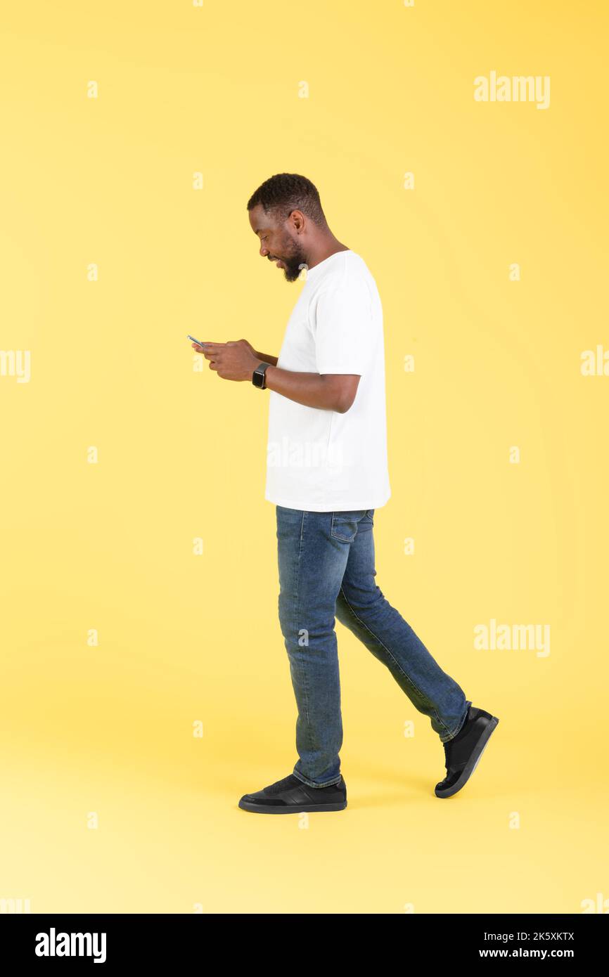 Black man walking side view hi-res stock photography and images - Alamy