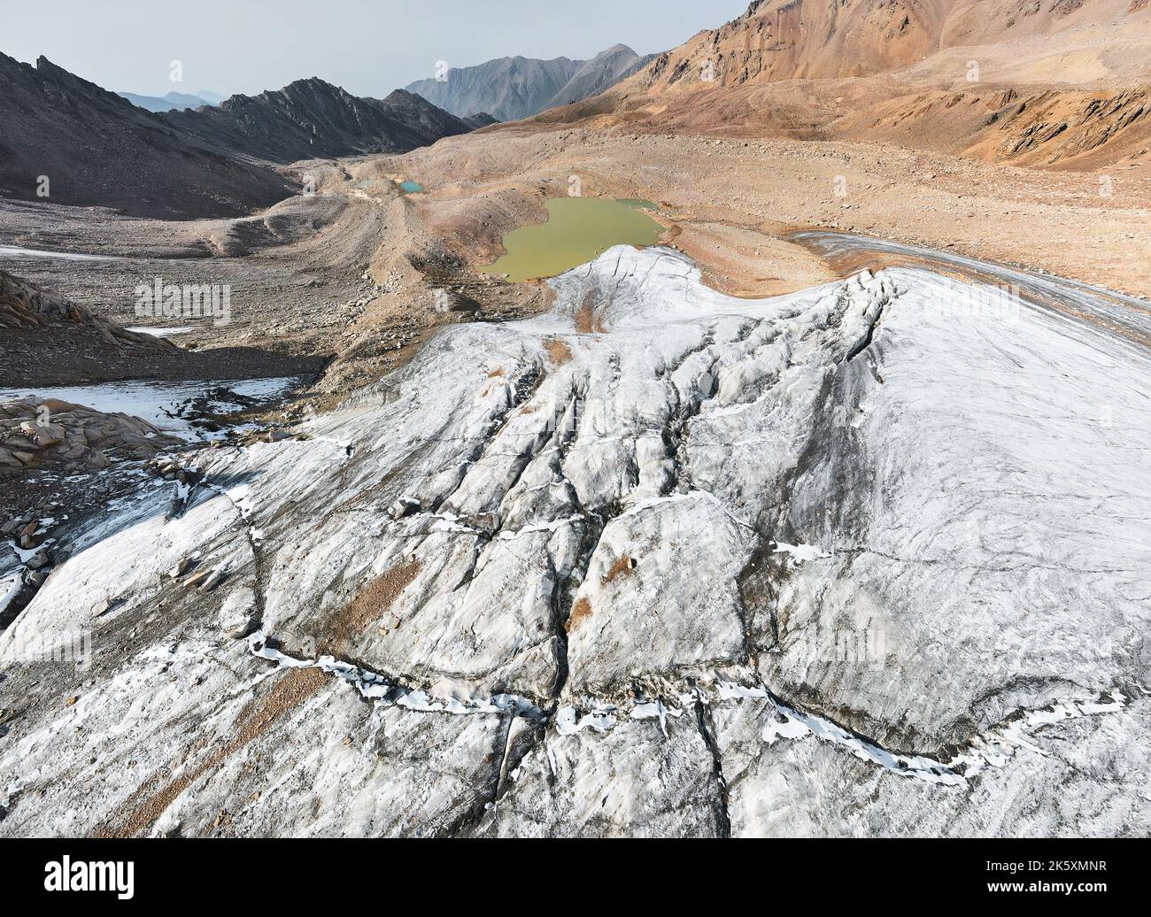 Beautiful scenery of the ice glacier with crack and mountain lakes near Almaty city, Kazakhstan. Aerial shot with drone outdoor hiking Stock Photo