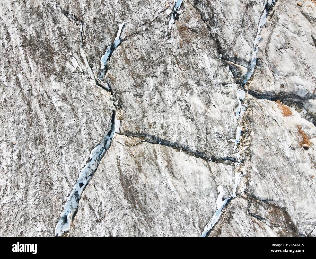 Beautiful scenery of the ice glacier with crack near Almaty city, Kazakhstan. Aerial shot with drone top down view outdoor Stock Photo