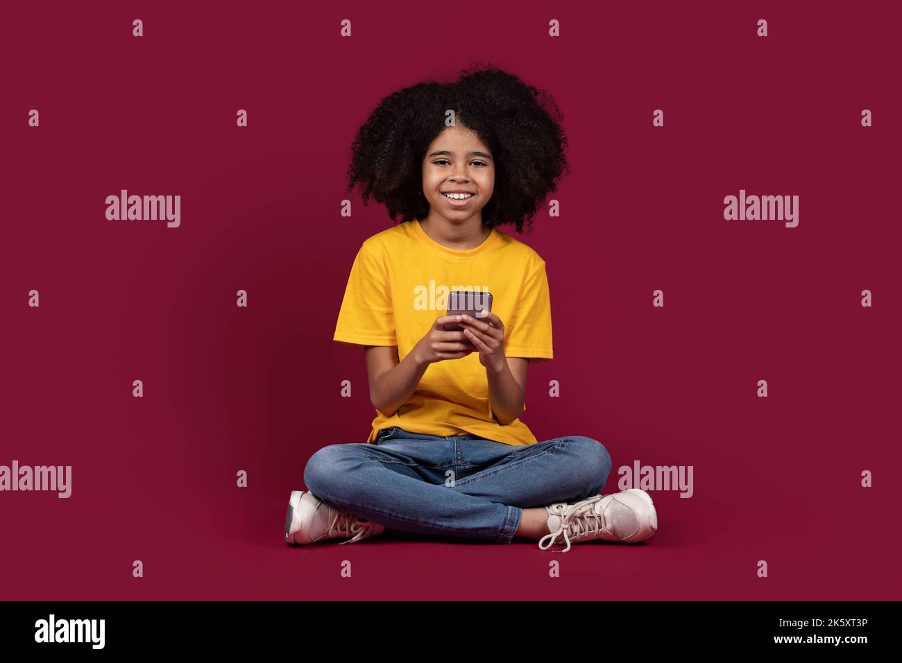 Cute african american preteen girl using cell phone Stock Photo - Alamy