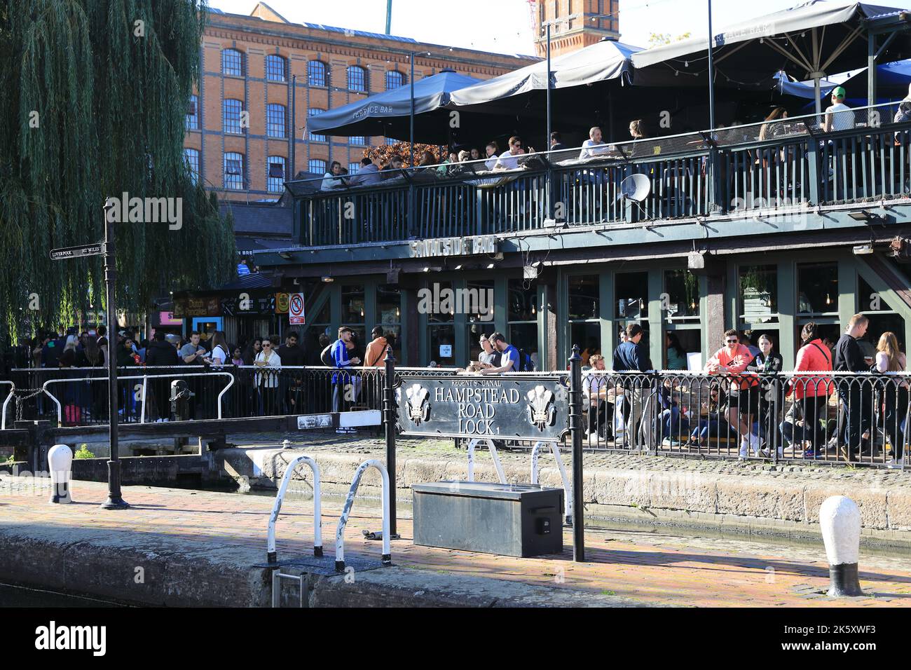 Lively Canalside Bar on Camden Lock by Regents Canal busy in warm