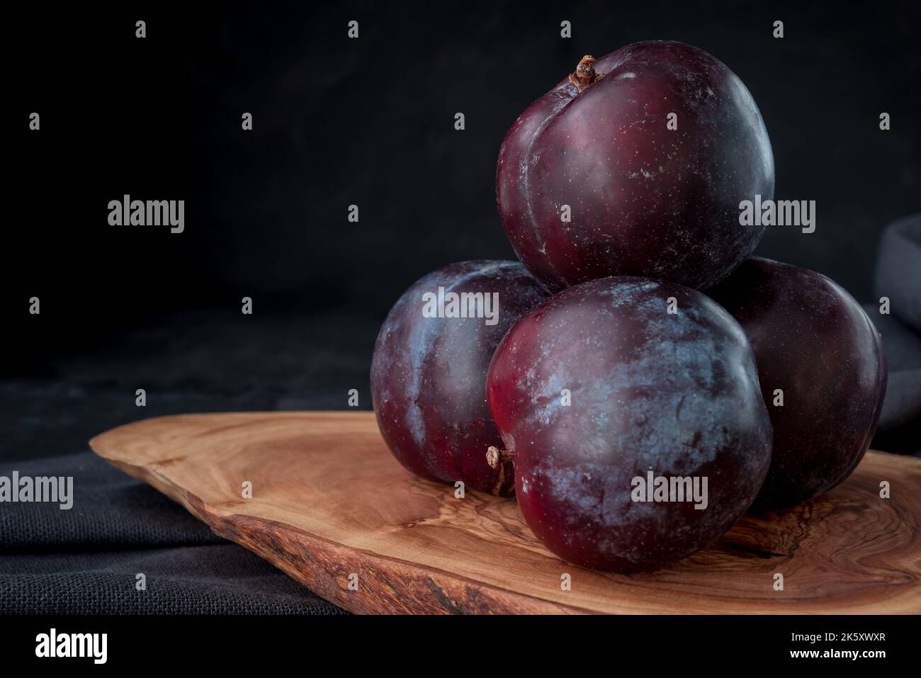 Fresh purple plum on black background Stock Photo