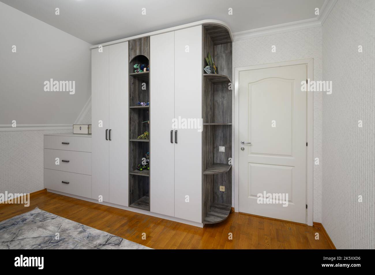 Large white cabinet in living room with wooden floor Stock Photo