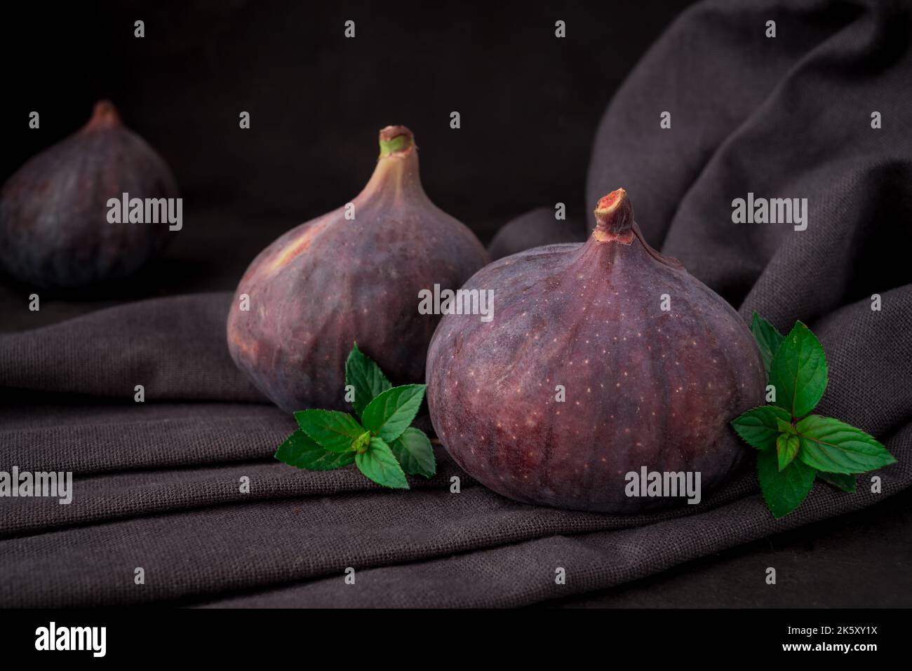 Fresh sweet fruit figs on a dark background Stock Photo
