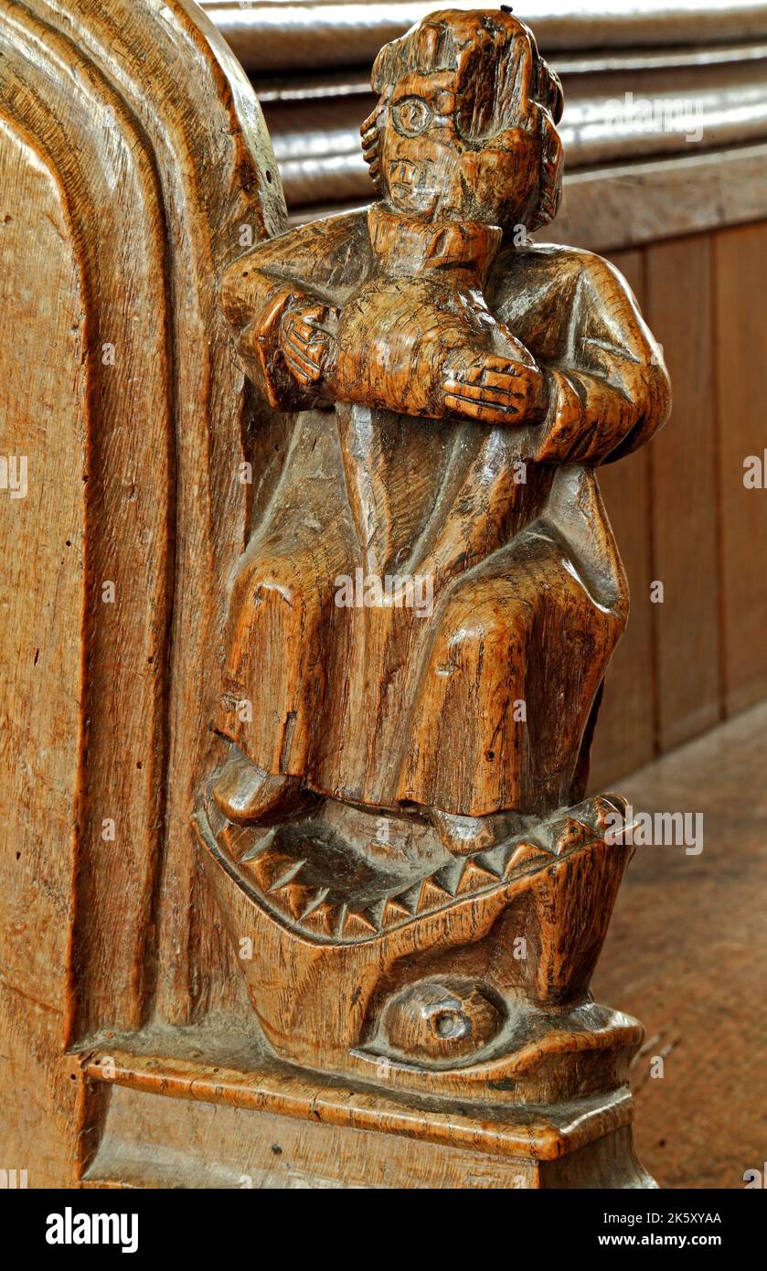 medieval bench end, Drunkenness, Jaws of Hell, one of the Seven Deadly Sins, woodcarving, Thornham, Norfolk, UK Stock Photo