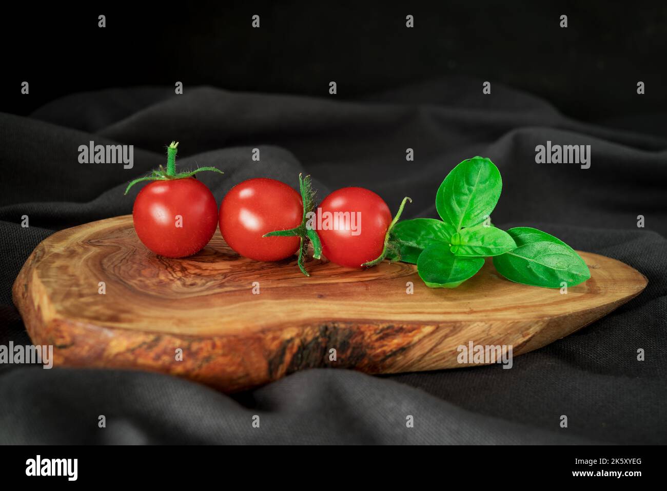 red tomatoes branch on table background, healthy food Stock Photo - Alamy