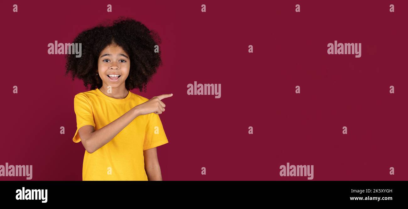 Happy african american kid girl pointing at copy space Stock Photo - Alamy