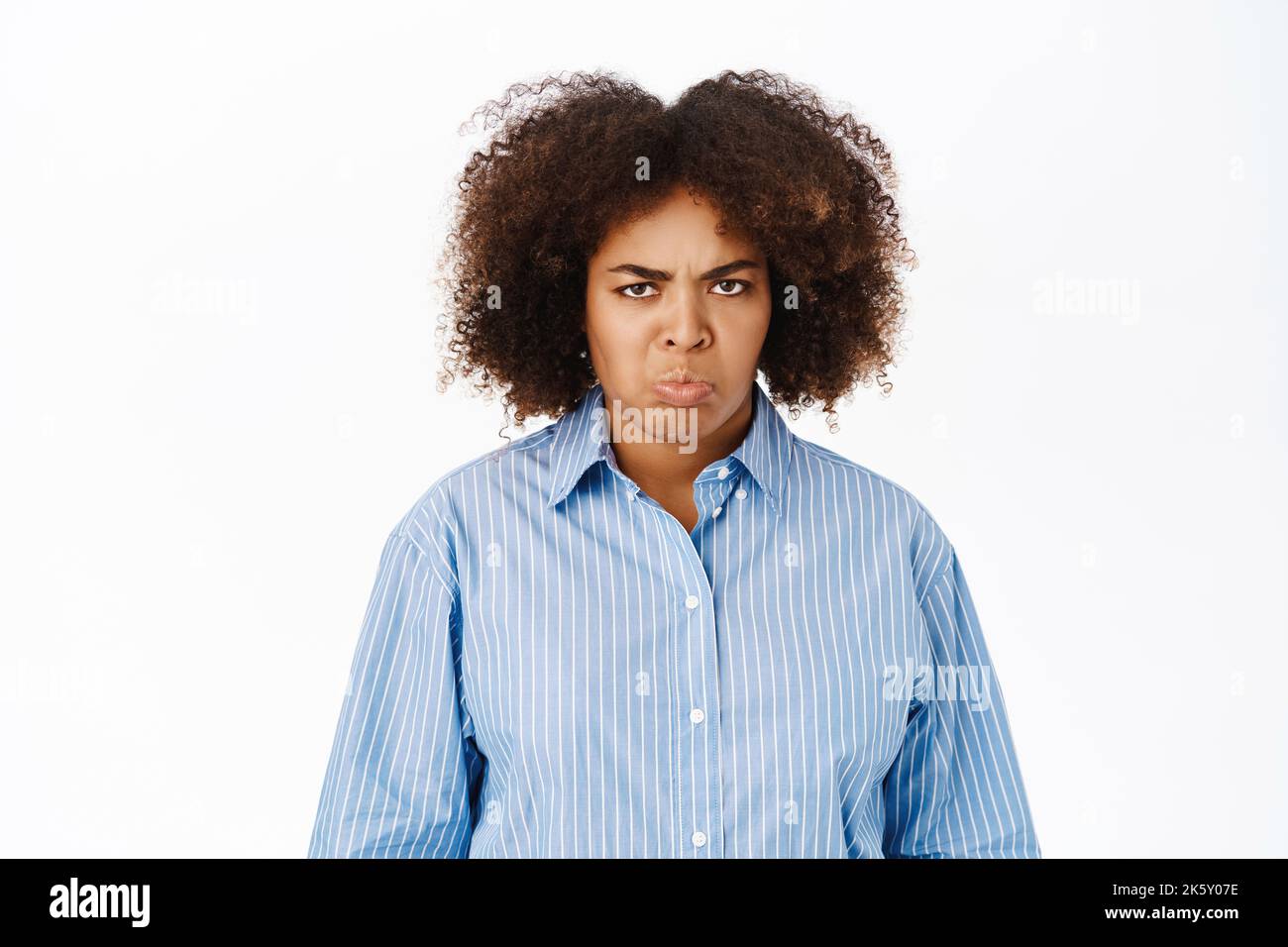 Grumpy african american woman, sulking and looking upset, standing over ...