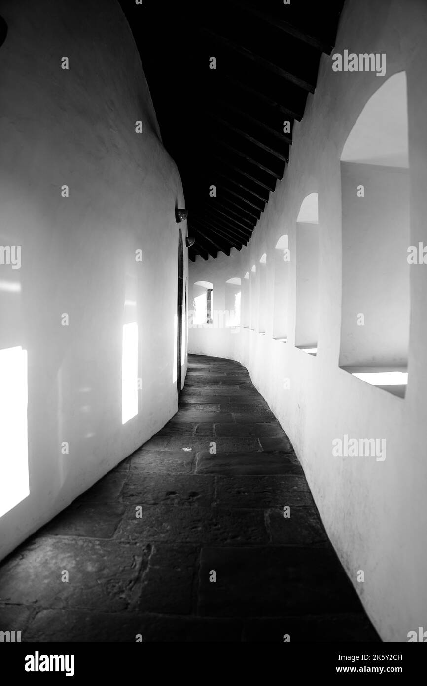 A grayscale of old building walls with small windows Stock Photo - Alamy