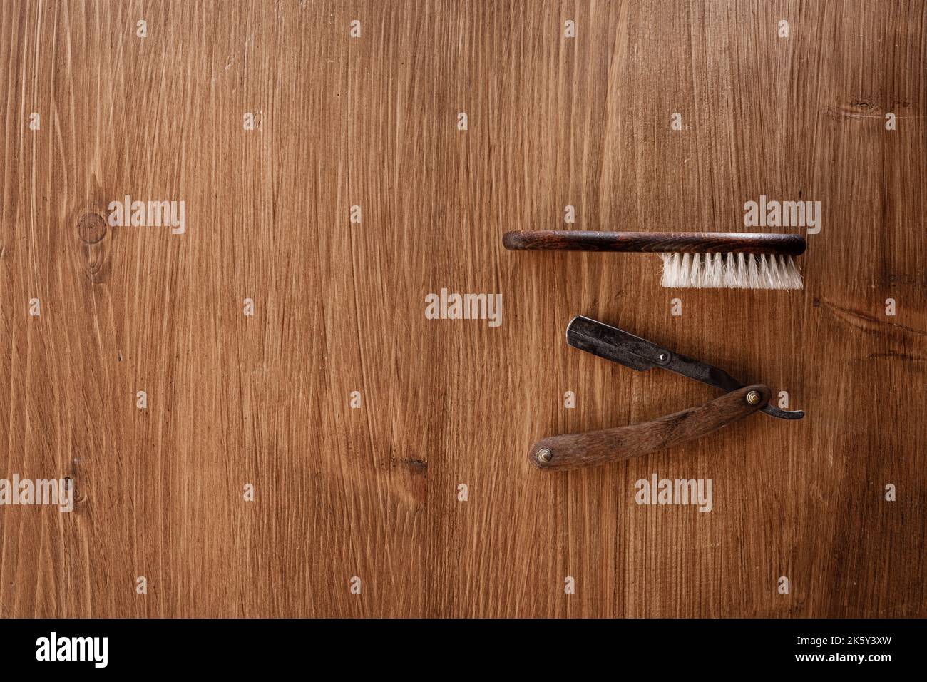 Vintage straight razor with wooden handle and brush isolated on wooden ...
